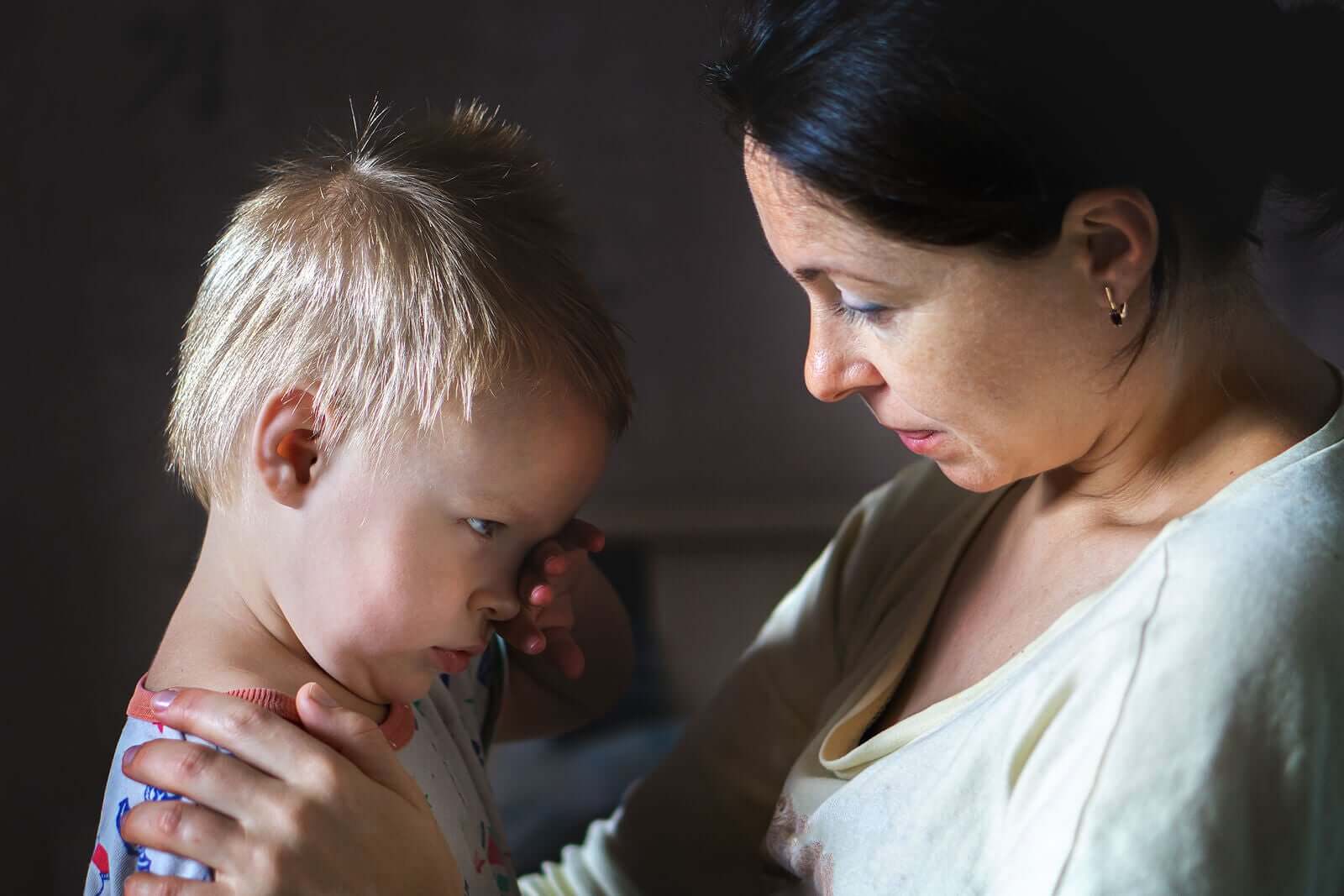 A mother talking to her crying toddler.