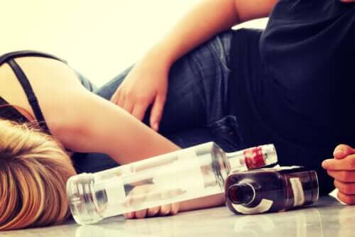 Teenagers lying on the floor drunk after drinking alcohol.