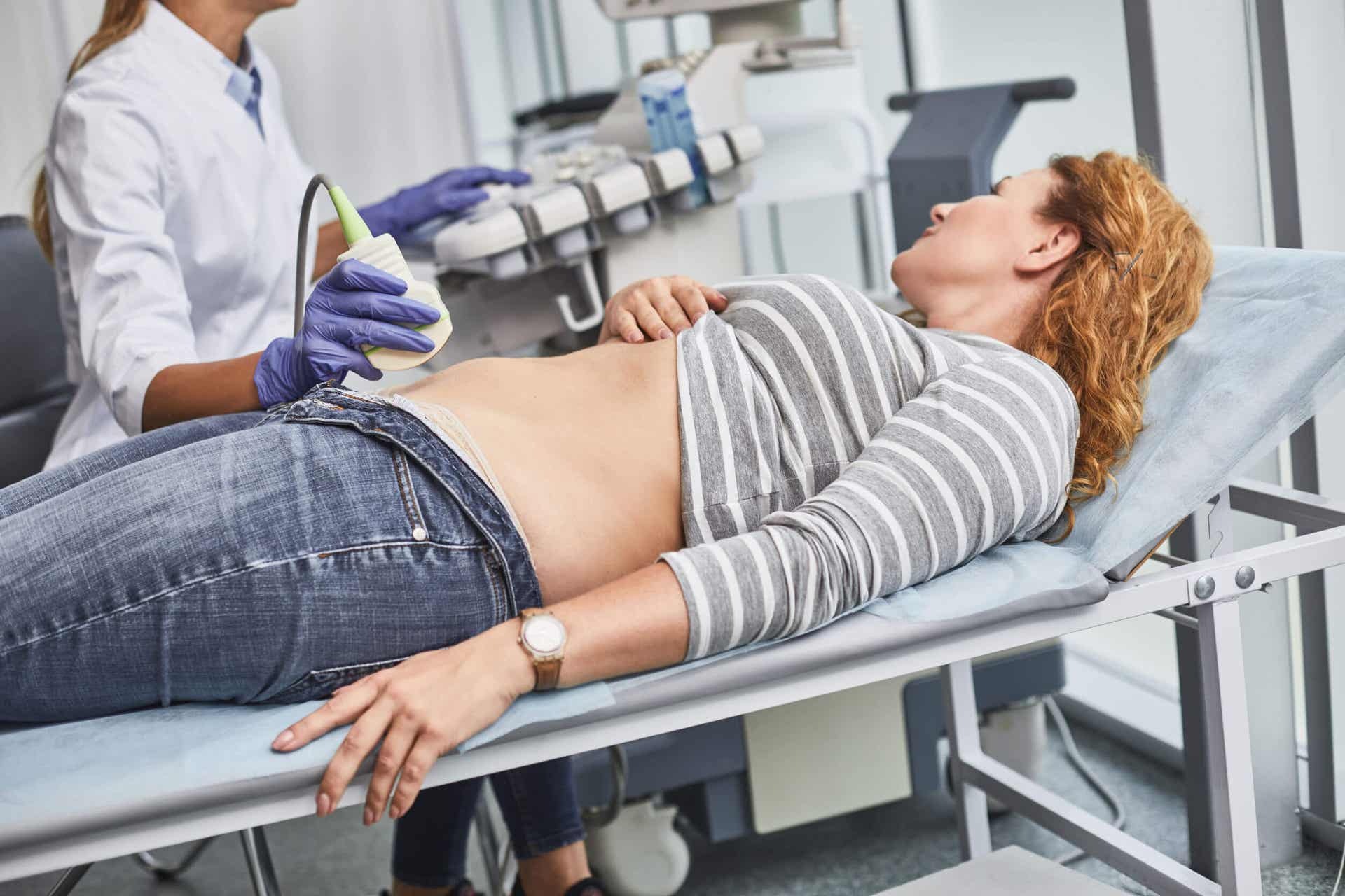 A woman in her first trimester undergoing an ultrasound.