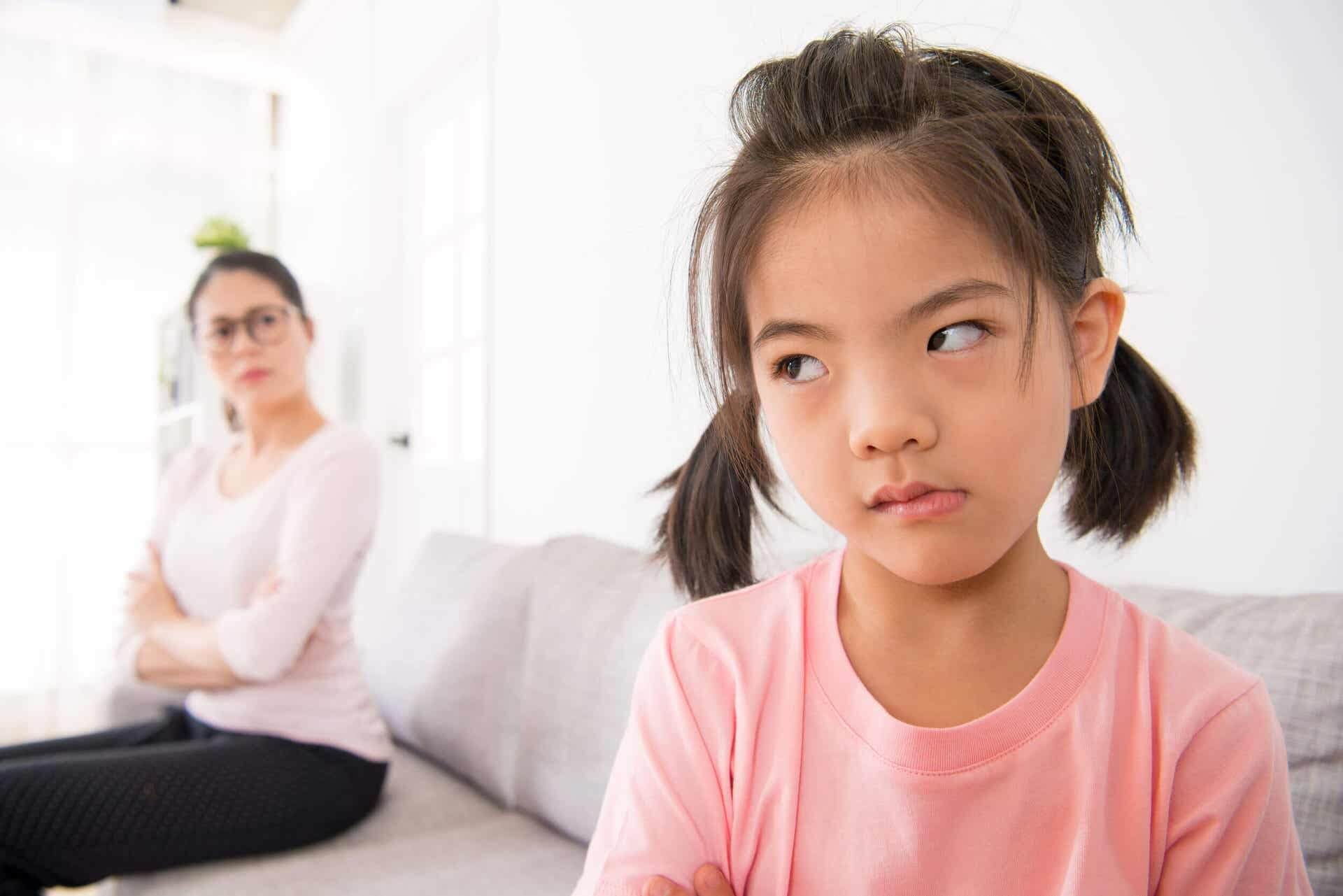 Girl very angry with her mother, she doesn't want to give her a hug.
