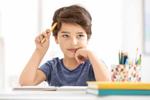 A child that's daydreaming while doing his homework.