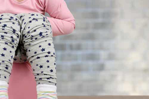A young girl sitting on a potty.