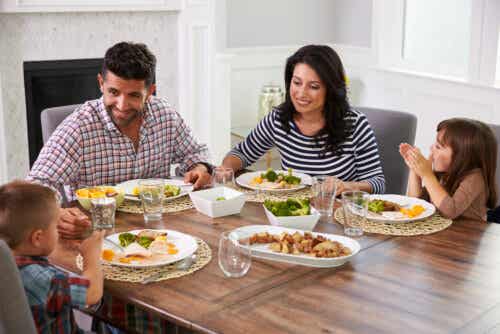 A family enjoying a meal at the dining room table.
