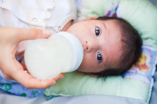 A newborn drinking from a bottle.