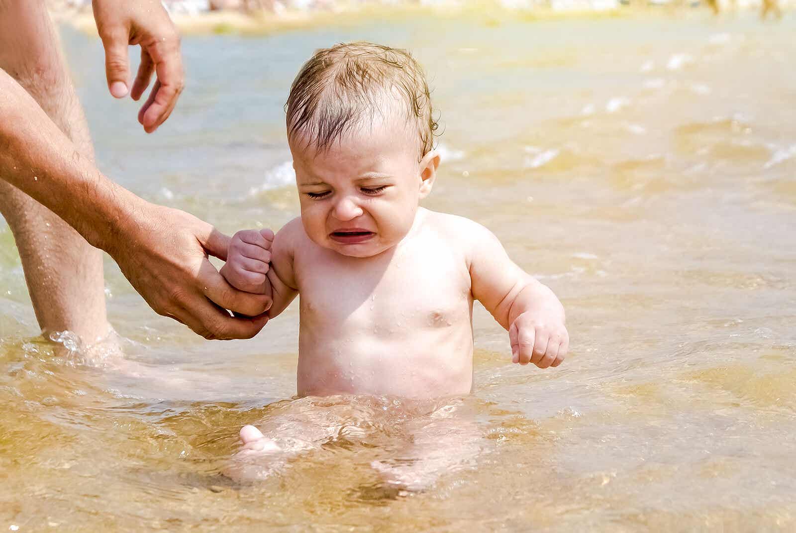 A baby crying in the water.