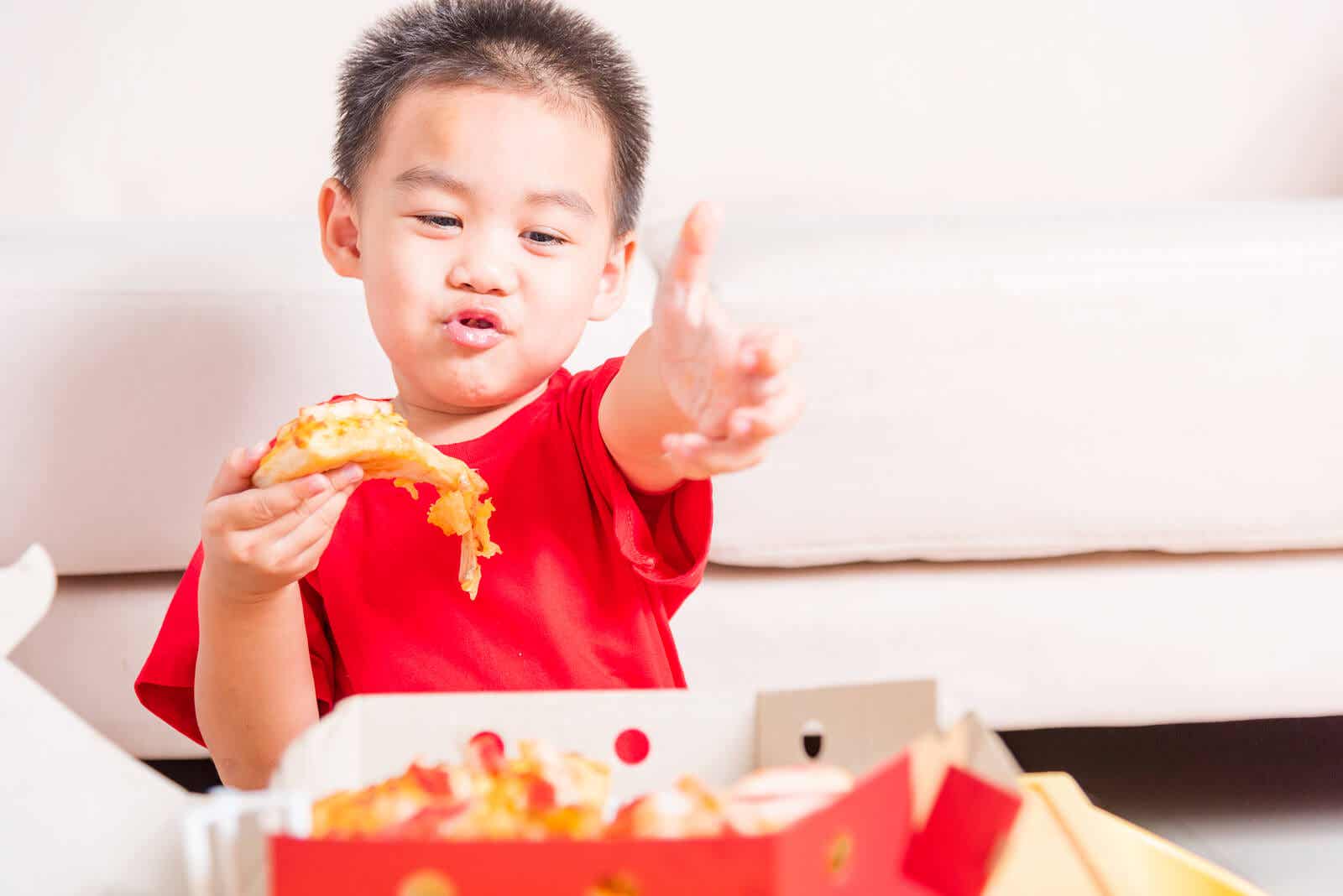 A toddler eating junk food.