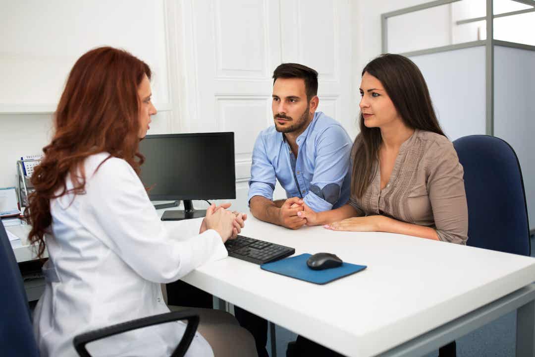 A couple talking with a fertility specialist.