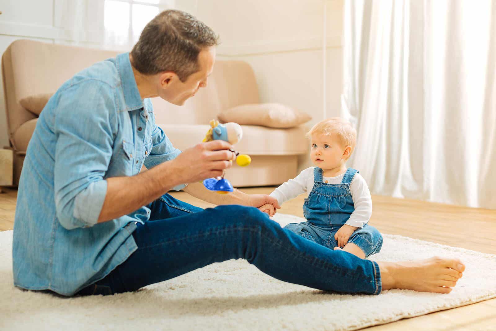 A father sitting on the floor and communicating with his baby girl.