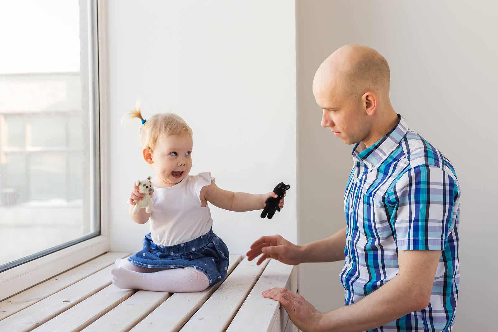 A toddler communicating with her dad.