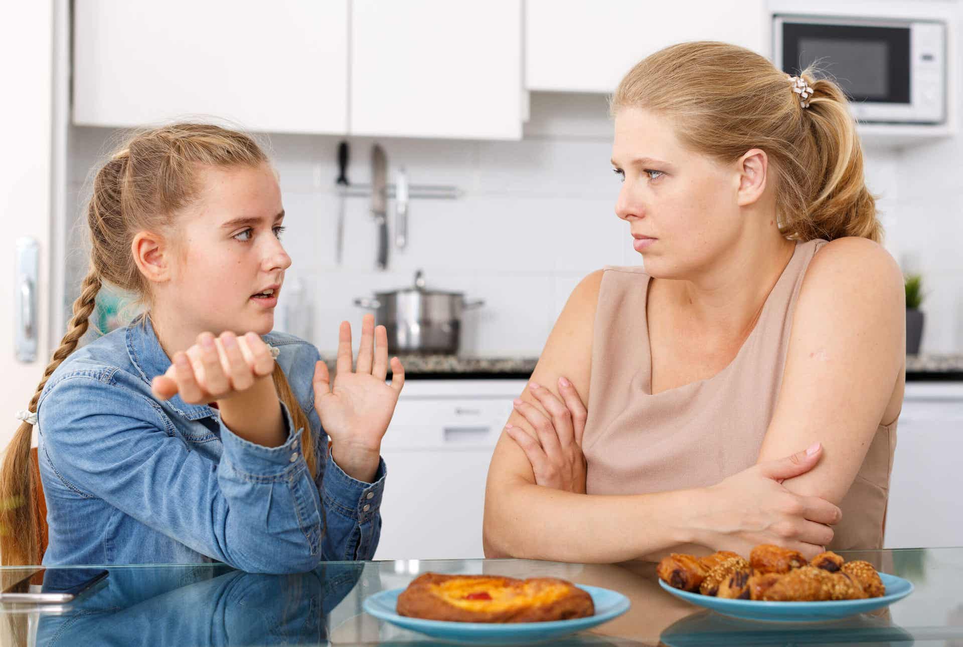 A teenage girl talking to her mother.