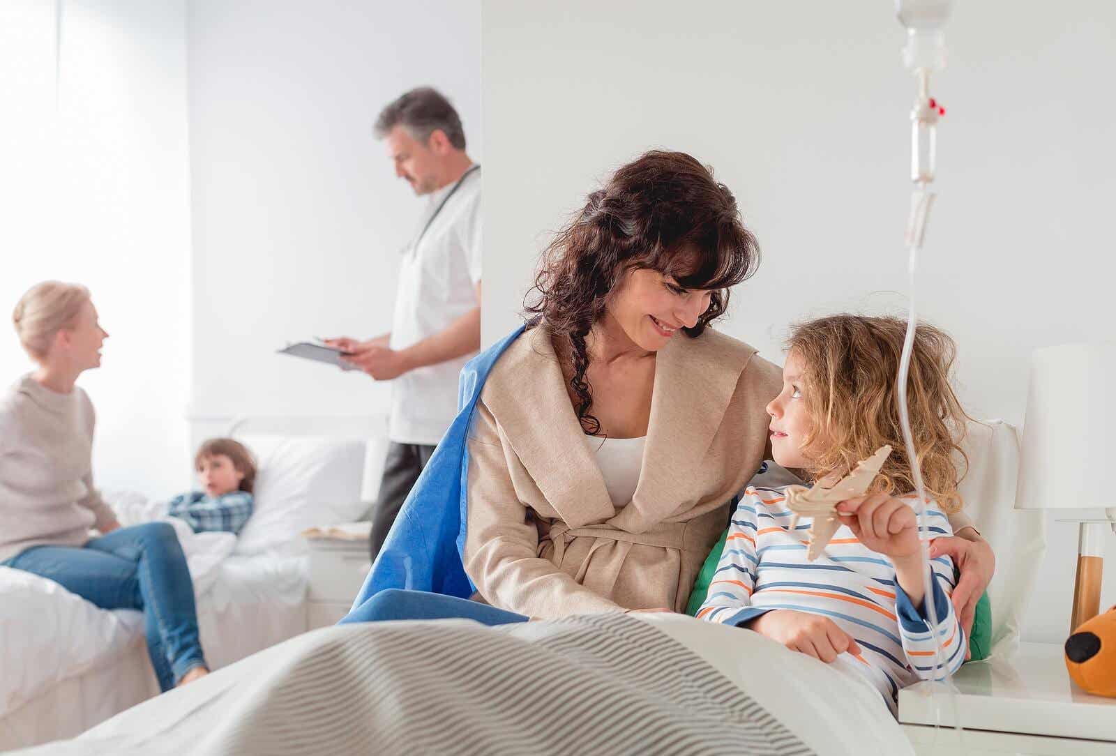 A young girl in a hospital bed, connected to an IV, talking to her mom.