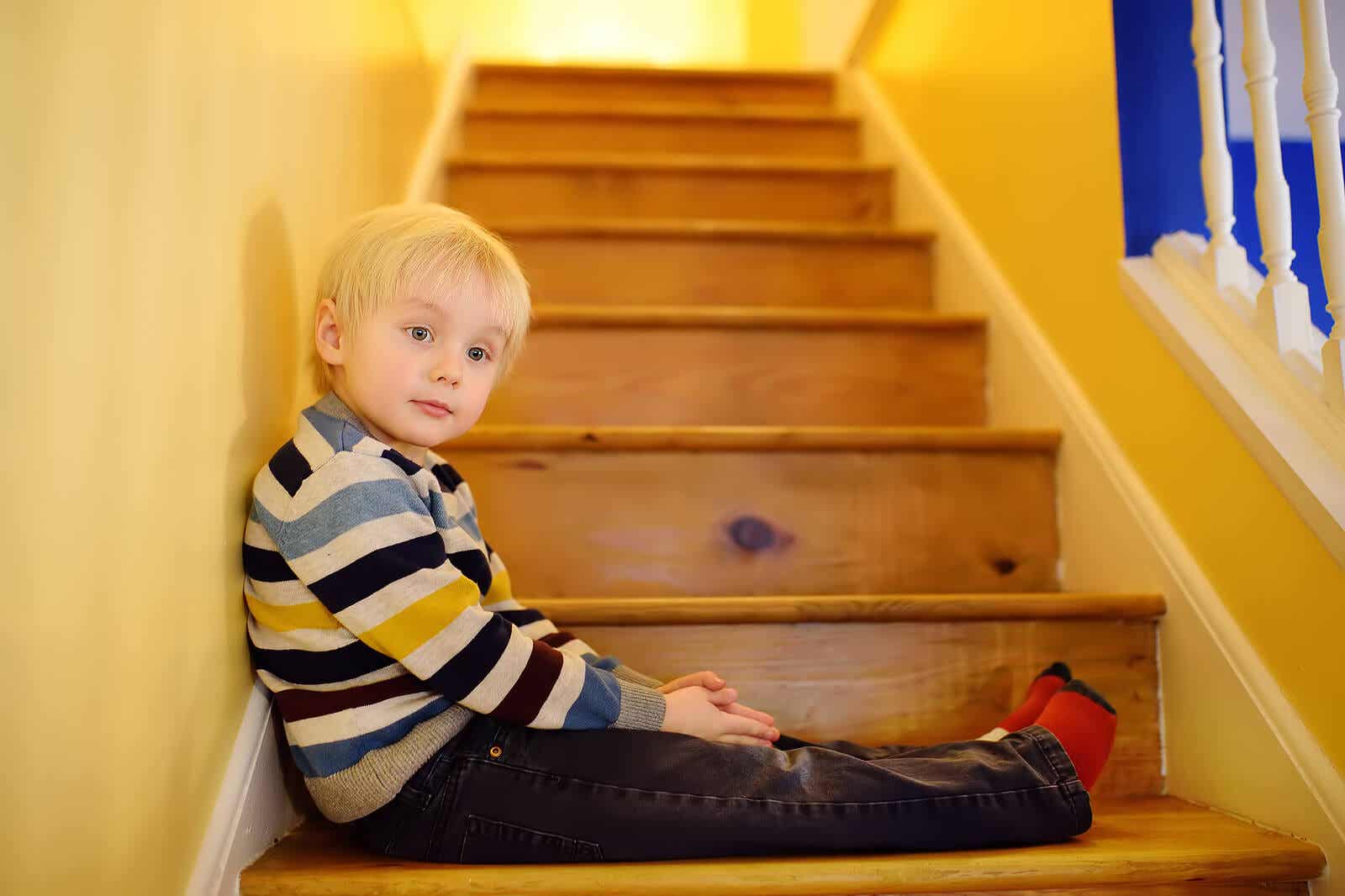 A child sitting on a staircase.