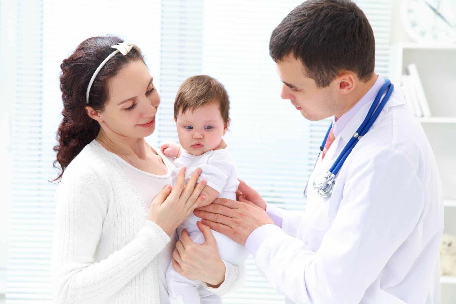 A mother handing her baby to a pediatrician.