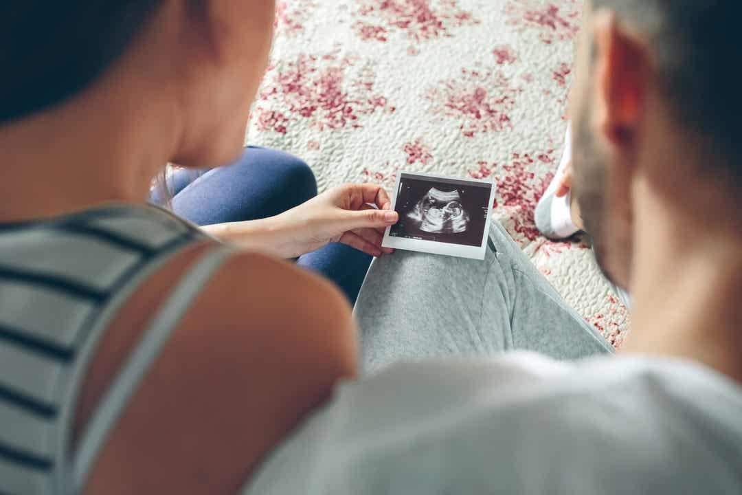 Parents looking at an ultrasound image.