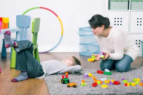 Mother picking up toys.