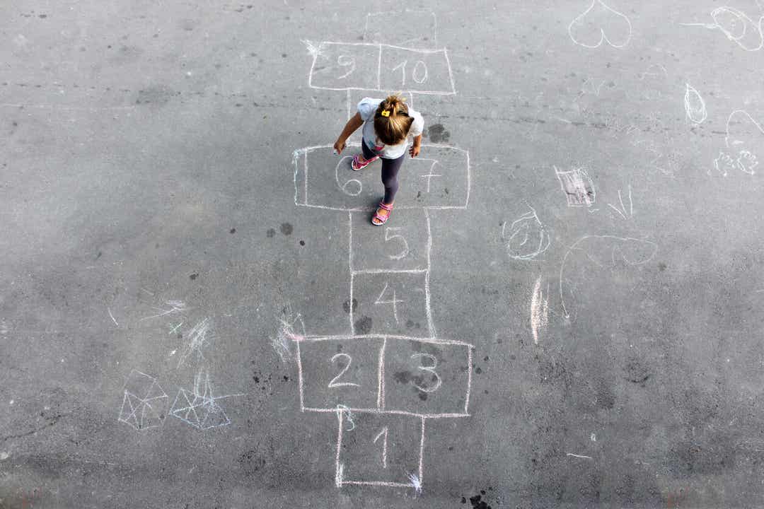A child playing hopscotch during recess.