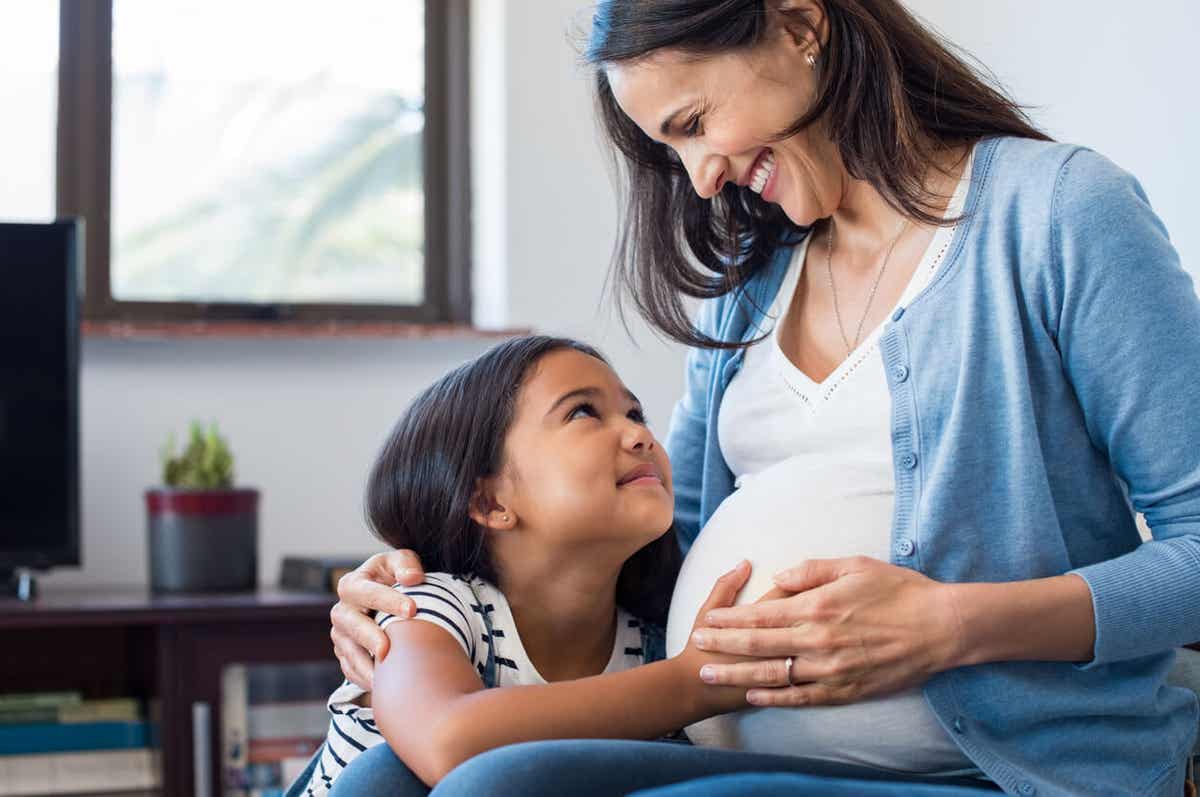 A mom and daughter laughing together.