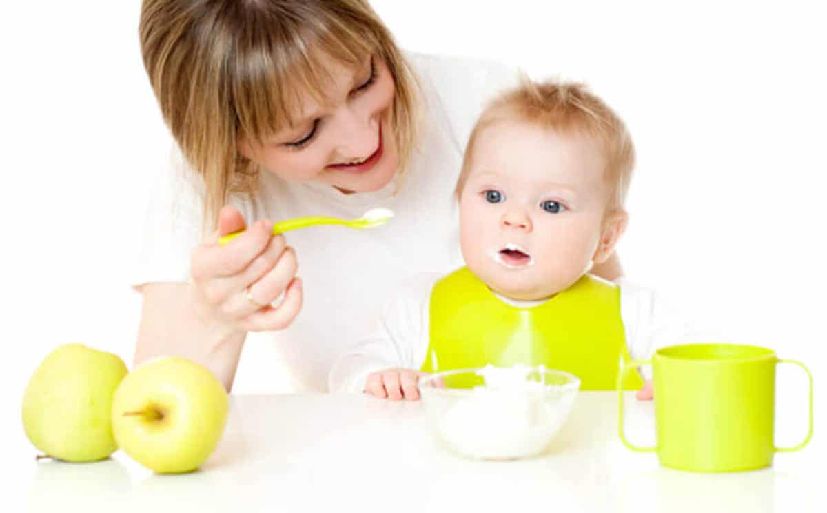 A mom feeding her baby.