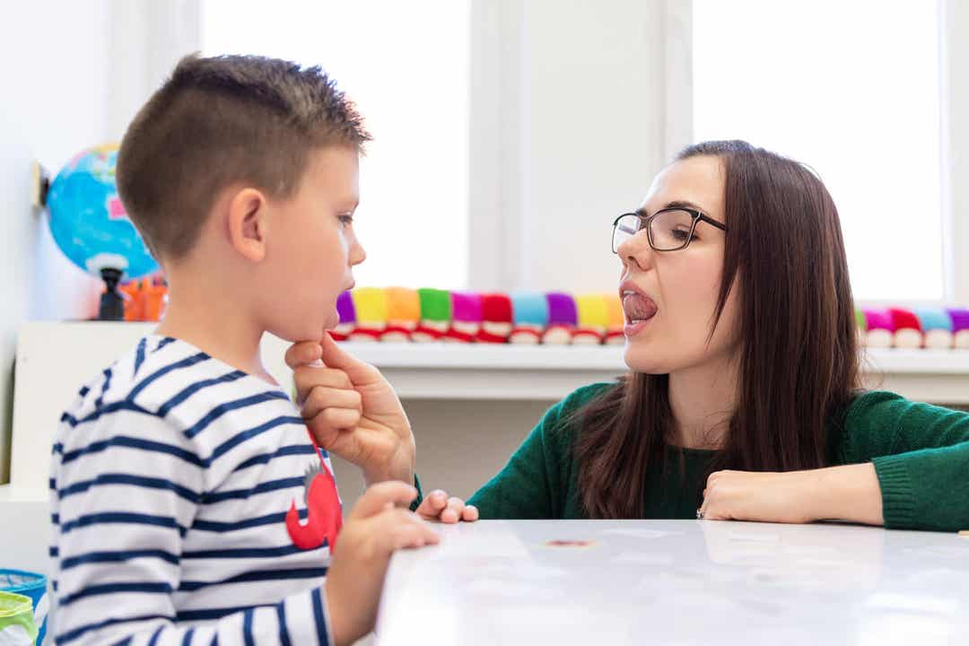A speech therapist working with a little boy.