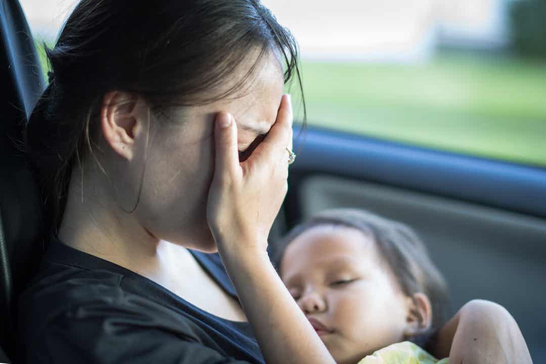 Sad mother crying in the car 