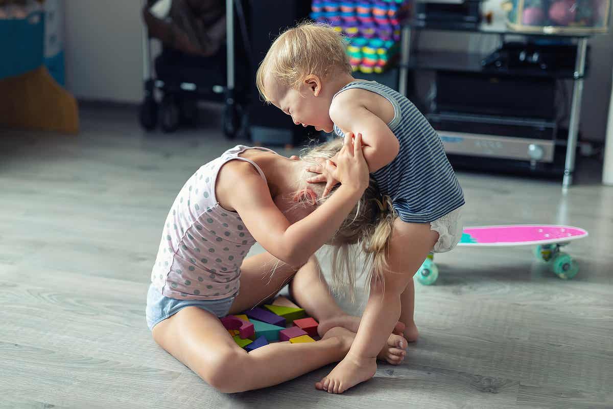 Two siblings fighting at home.