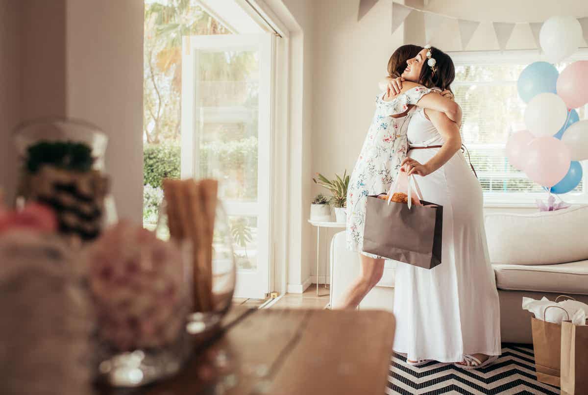 Women hugging at a baby shower.