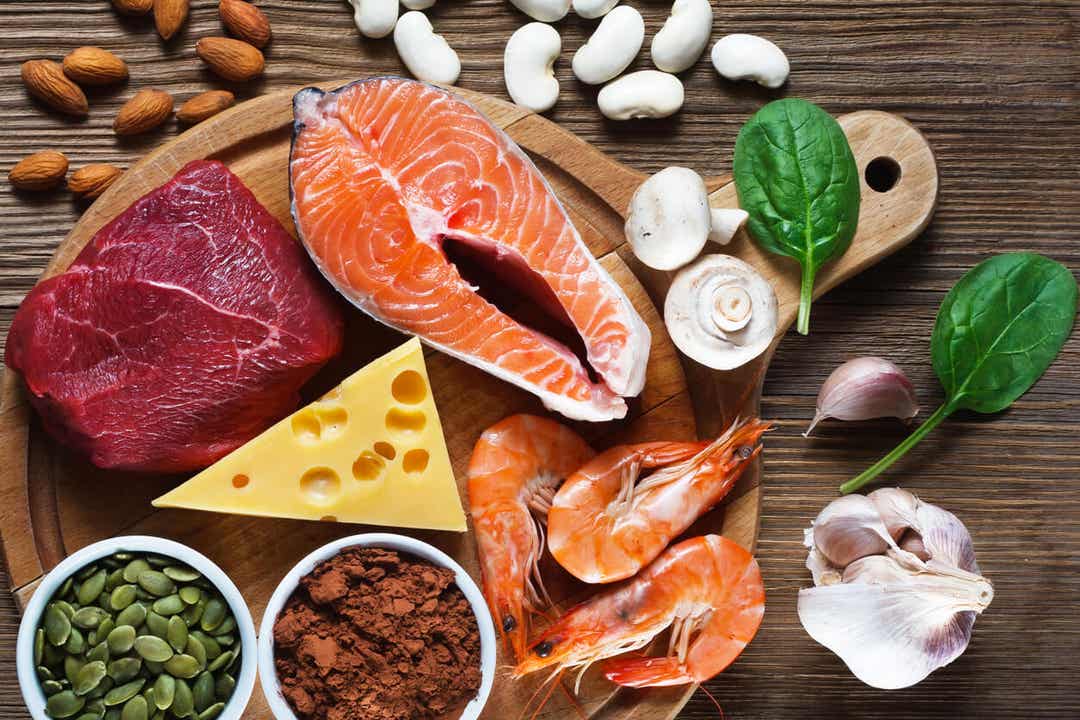 Different food sources of zinc, including salmon, shrimp, meat, cheese, seeds, and legumes.