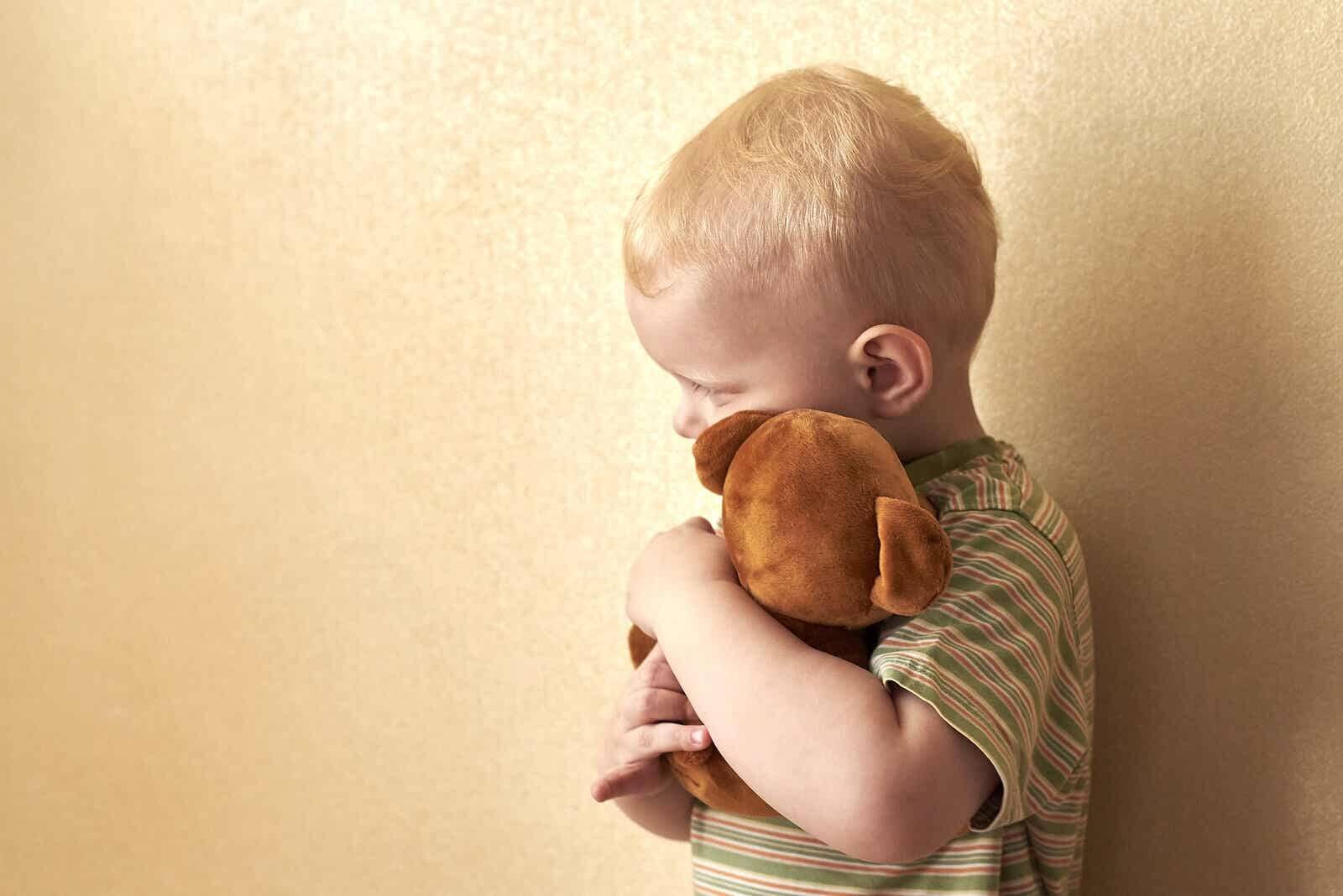 Child hugging a stuffed animal because he’s afraid of death.