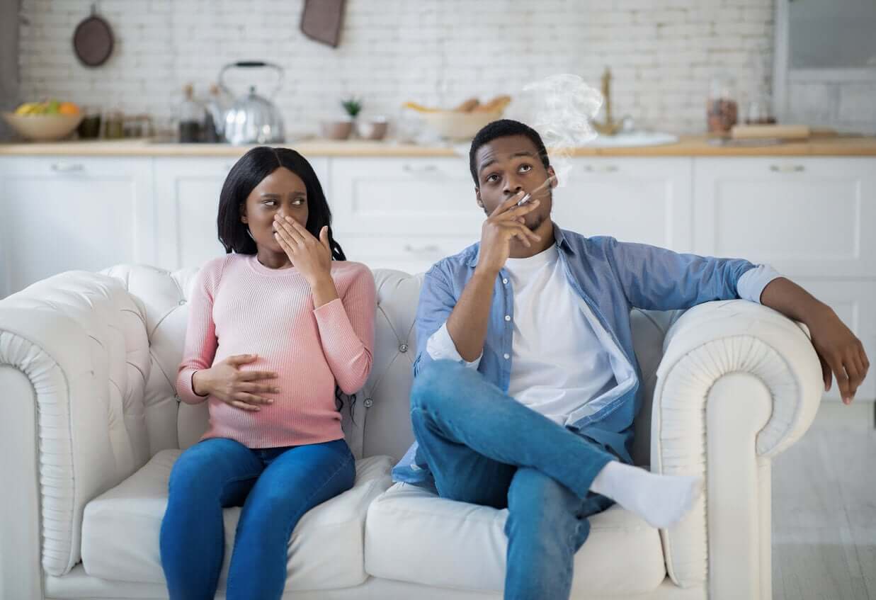 A pregnant woman experiencing aversion to the smell of cigarette smoke.