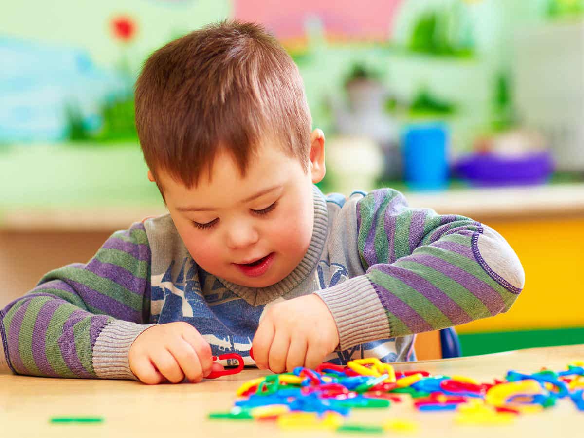 A child playing with toys at a table.
