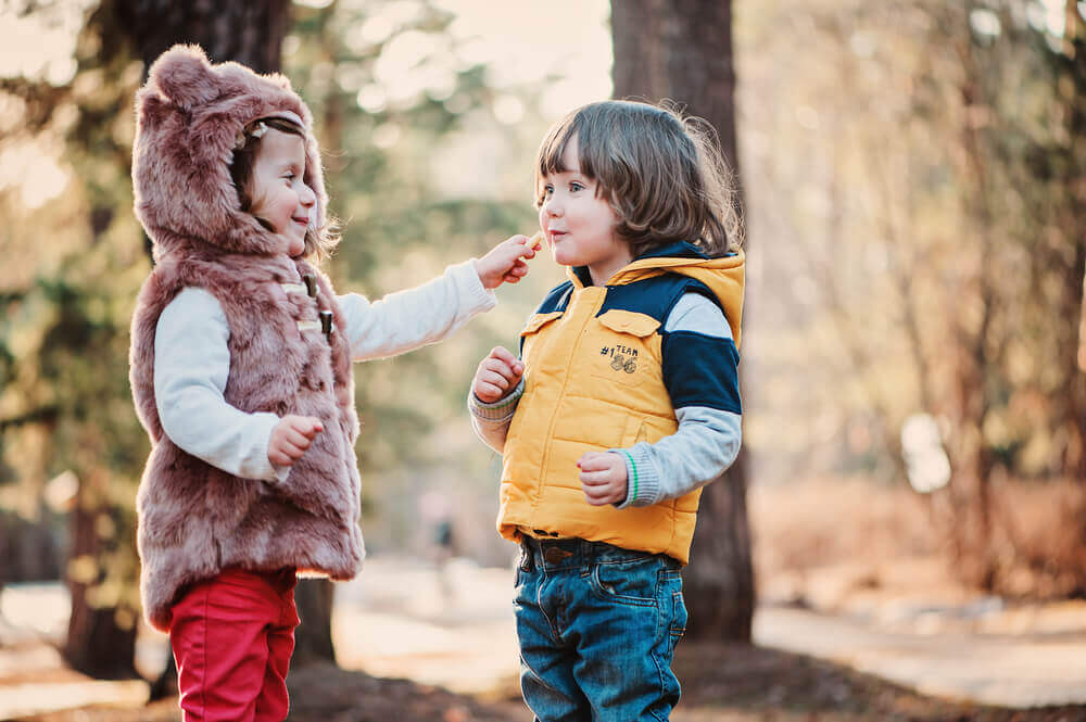 Two toddlers practicing social skills. 