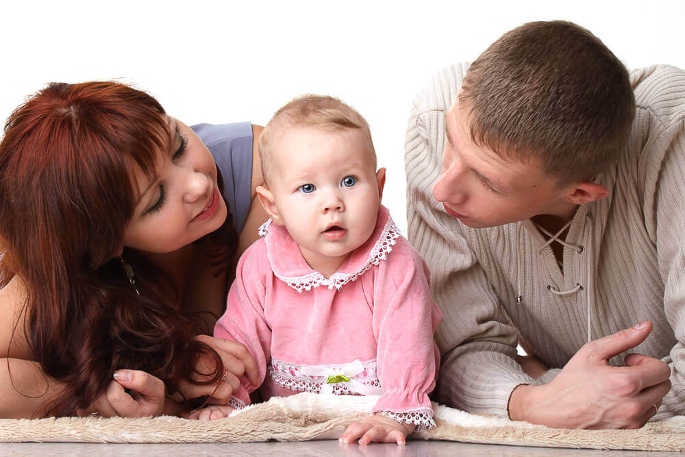 Parents talking to their baby.