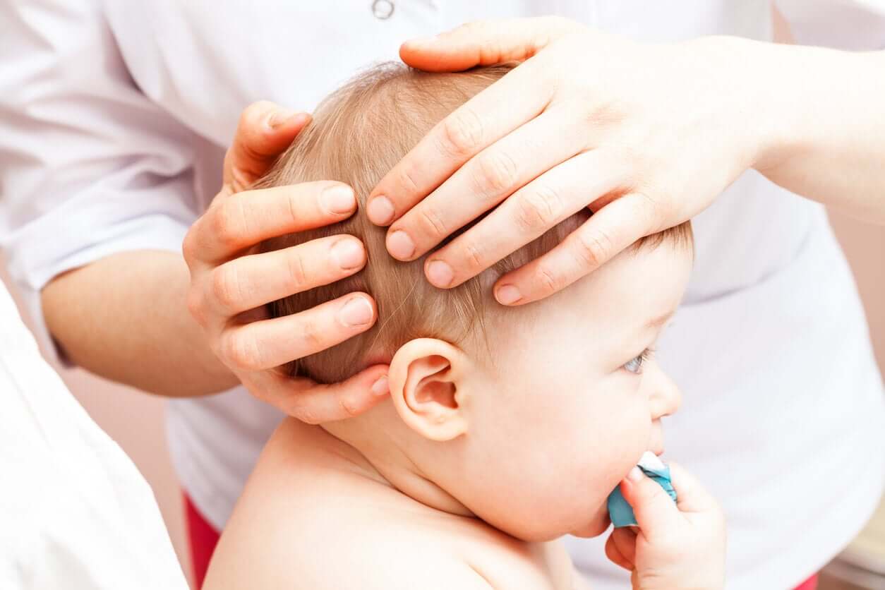 A doctor examining a baby's head.