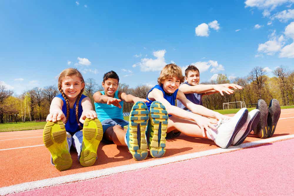Children stretching on a track.