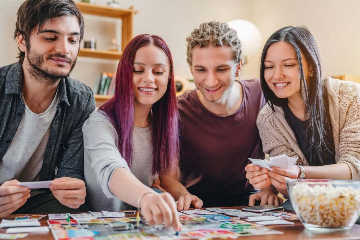 Four teens playing a board game.