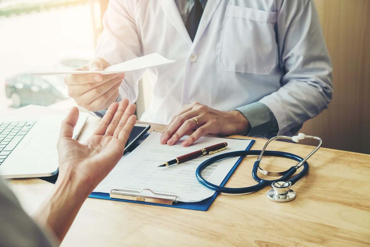 A doctor giving a prescription to a patient.