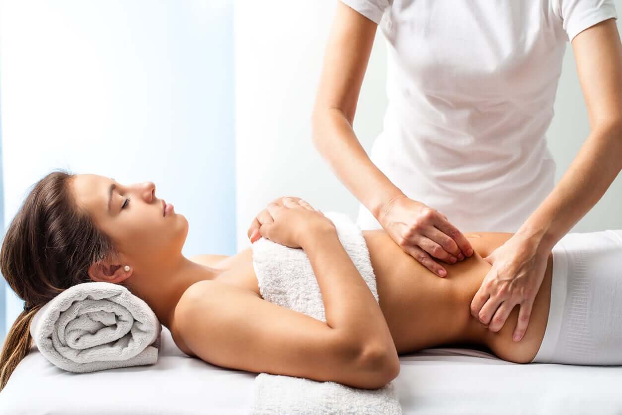 A woman receiving an abdominal massage.