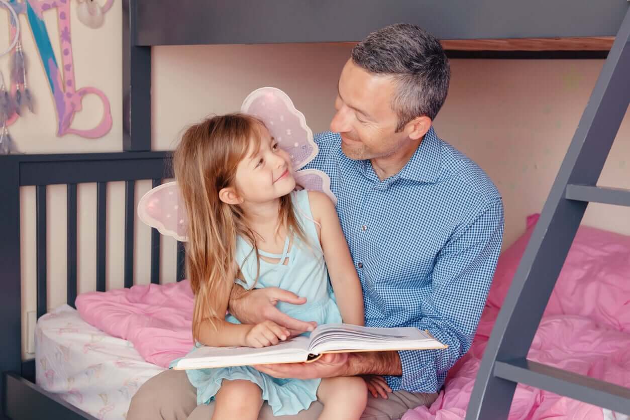 A father reading a story to his daughter.