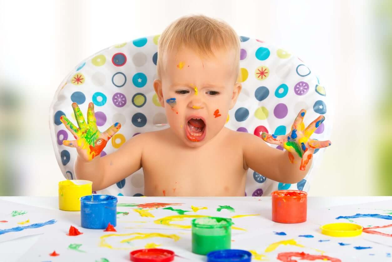 A baby finger painting.