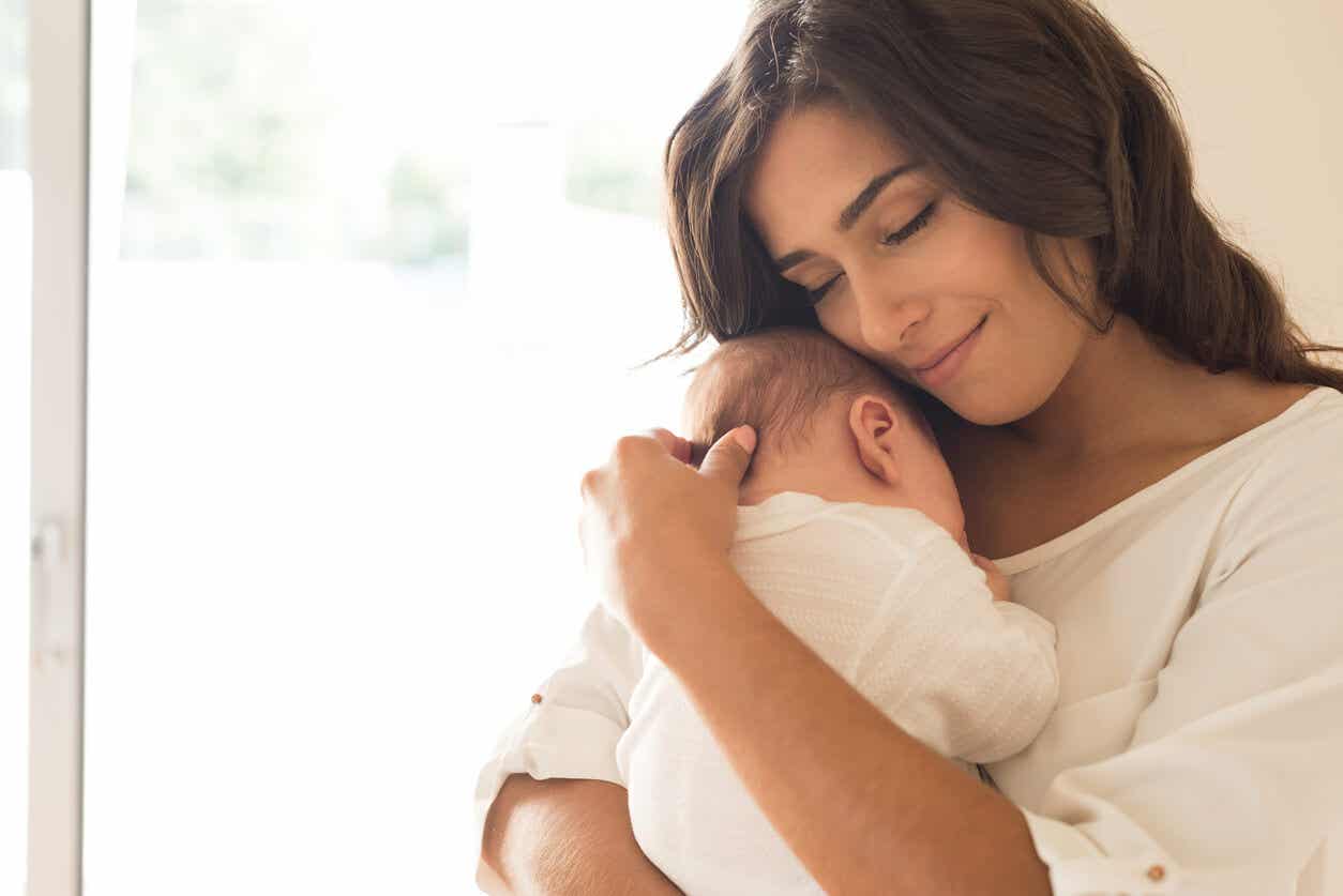 A mother embracing her newborn.