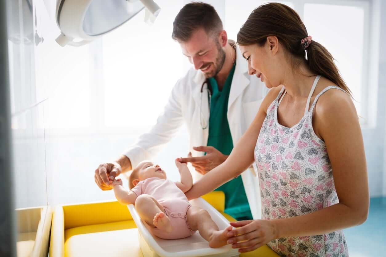 A pediatrician examining a baby girl.