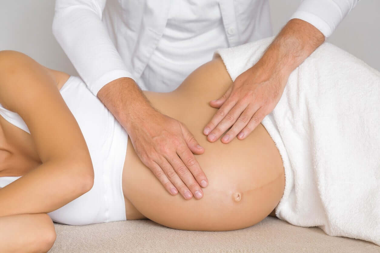 A pregnant woman getting a belly massage.