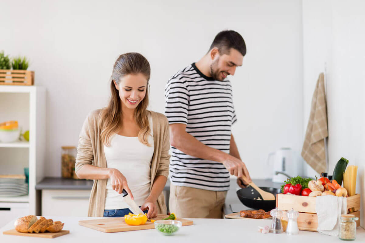 A couple cooking together.