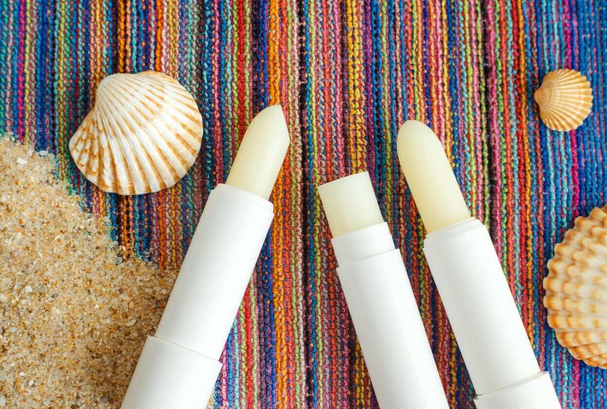 Three tubes of lip sunscreen.