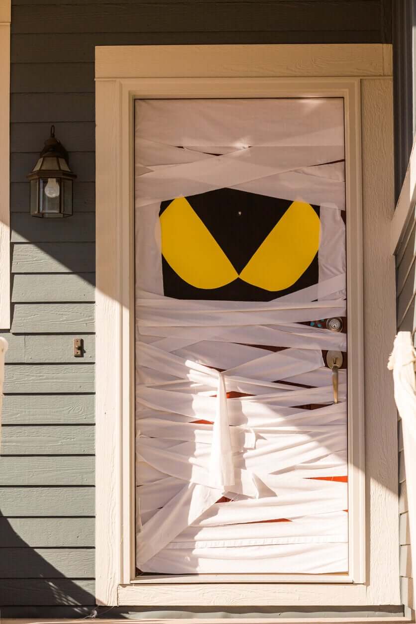 A front door decorated to look like a mummy.