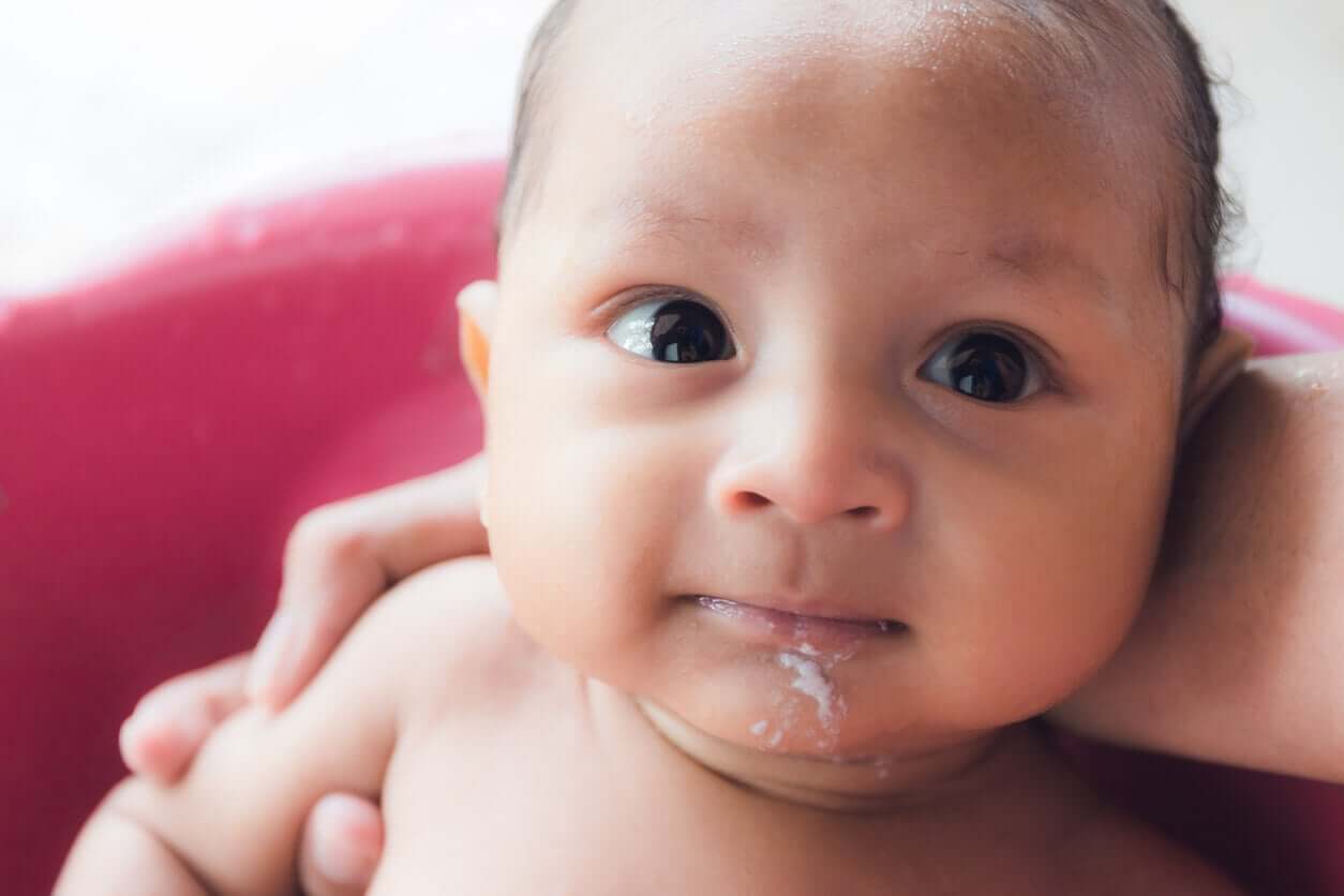 A baby with spit up on his chin.