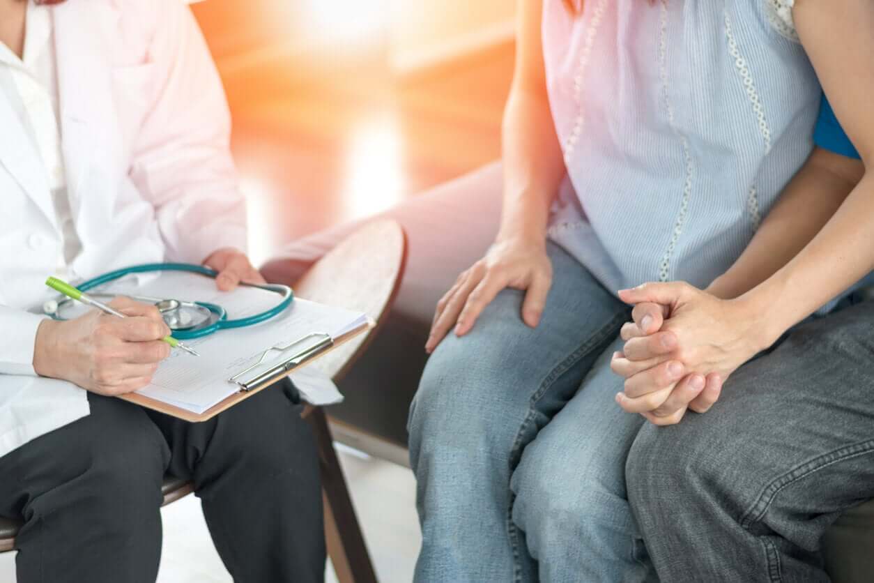 A couple talking with a fertility specialist.