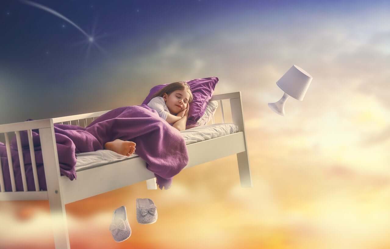 A little girl sleeping in a bed that's floating in the clouds.