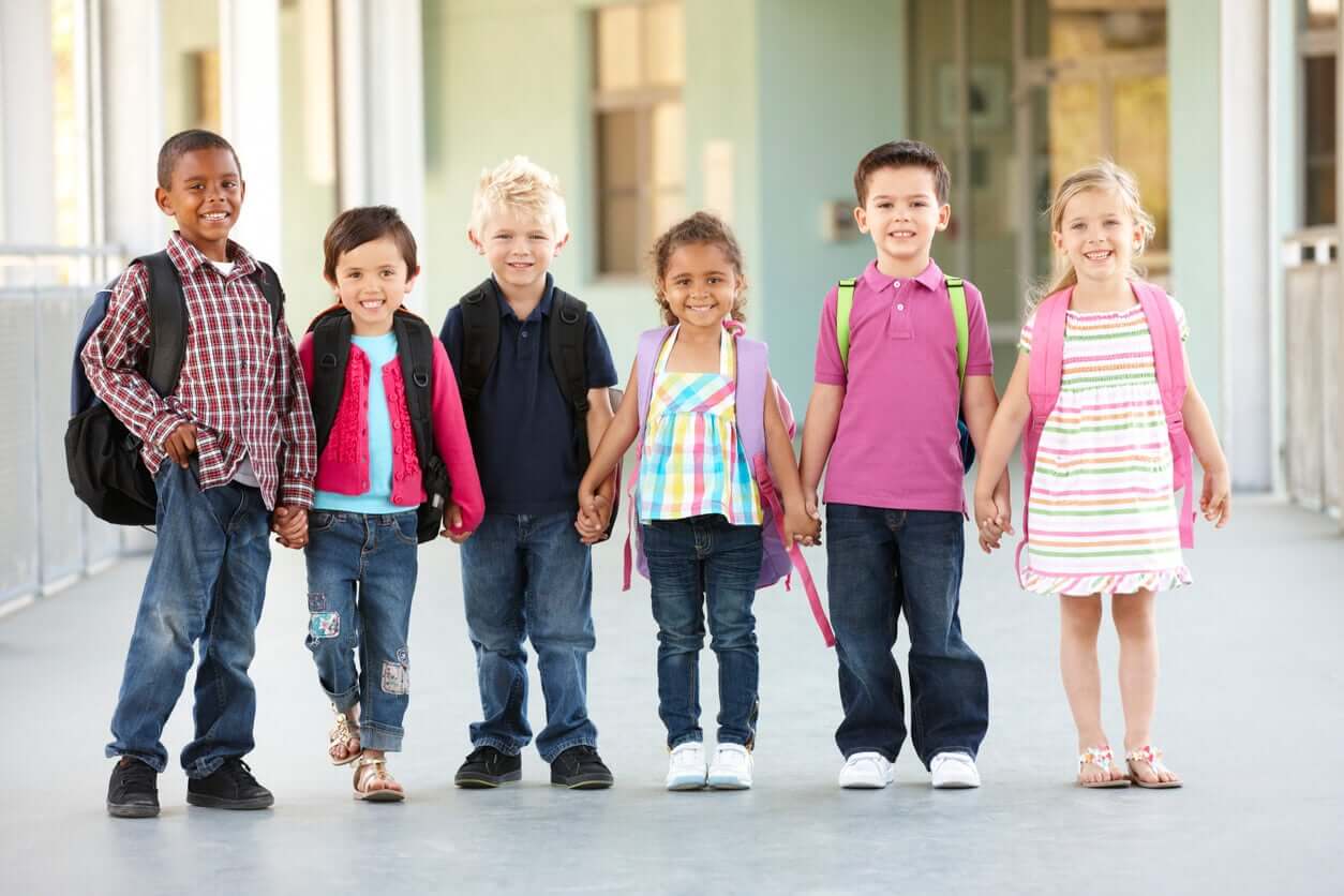 A multicultural group of children holding hands.