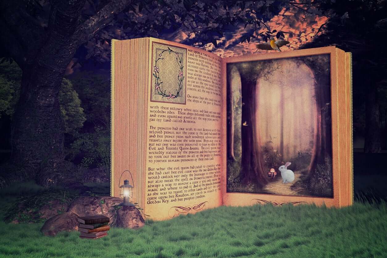 A giant story book standing in a lawn under a tree.